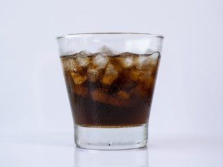 Cola soft drink with ice in the glass on isolated / white background