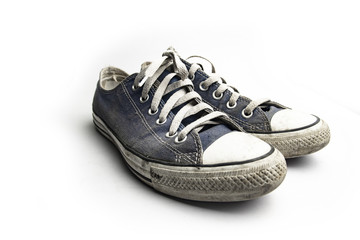 Dirty trainer canvas shoes on white background