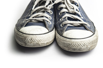 Dirty trainer canvas shoes on white background