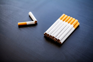Stop smoking concept on background with broken cigarettes. Heap of cigarettes. No smoking