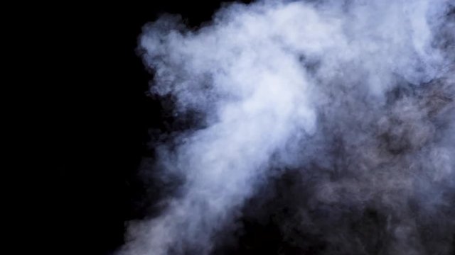 Beam of smoke over a black background in studio