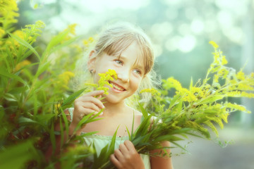 One girl at the Bush with bright yellow flowers.