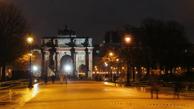 Time lapse of Arc de Triomphe du Carrousel, symbol of Napoleon military victories, and Tuileries garden by night. Famous Paris landmarks and popular travel destinations. Tourism and vacations concept