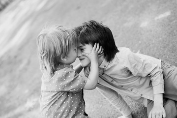 two cute brothers hug and fool around in the yard