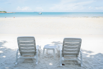 Fototapeta na wymiar empty beach chair over looking the clear blue sky and ocean