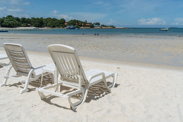 Fototapeta na wymiar empty beach chair over looking the clear blue sky and ocean