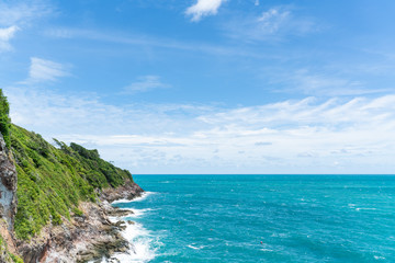Sea waves breaking against  cliff viewed from above.