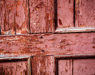 Old wooden surface with cracked pink oil-paint