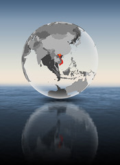 Vietnam on translucent globe above water