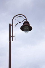 Photo of vintage Old Street Classic Iron Lantern On The Sky Background, Close Up