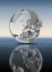Netherlands on translucent globe above water