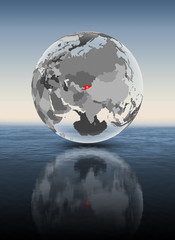 Kyrgyzstan on translucent globe above water