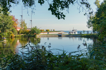 Obraz premium The pond is separated from the sea by a small scythe to which a small yacht of fishermen has moored