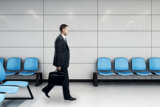 businessman with case in waiting hall