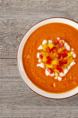 Soup gazpacho. Italian Cuisine. Plate with soup in a white plate on a rustic background. Top of the Vieux. Copyspace. Vertical shot.