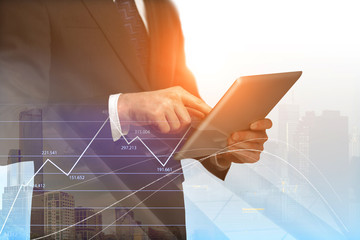 businessman with digital tablet and forex graphs