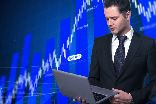 businessman with laptop and stock market screen