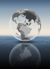 Suriname on translucent globe above water