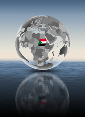 Sudan on translucent globe above water