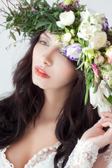 Beautiful woman in white lingerie and flowers Wreath