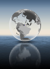 Fototapeta premium French Guiana on translucent globe above water