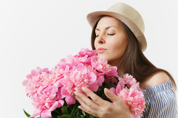 Close up young tender woman in dress hat holding, sniffing bouquet of pink peonies flowers isolated on white background. St. Valentine's Day International Women's Day holiday concept. Advertising area