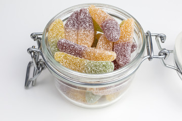gummy candy in the shape of cucumbers in a glass jar