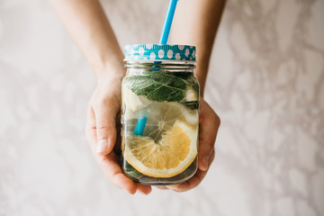 Homemade citrus lemonade or juice or mojito in a jar. Drink from citrus.