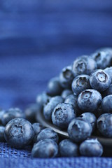 Blueberries close up on blue