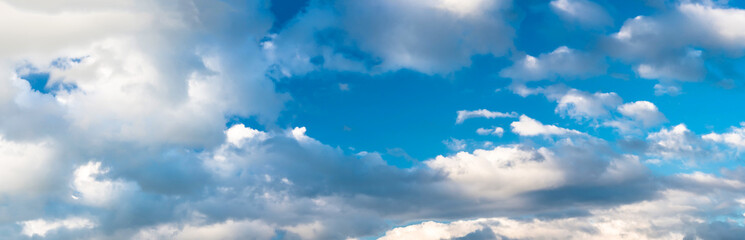 Panorama of beautiful blue sky with clouds on a hot summer day. High resolution