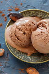 Artisanal chocolate ice cream on a bronze plate.