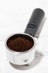 holder with ground coffee for coffee machine, selective focus