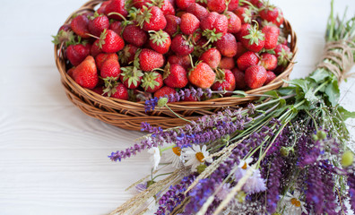 Strawberries in a wicker basket isolated on white background