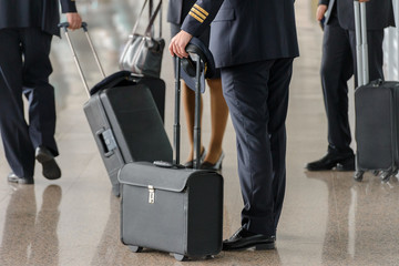 airplane pilots at the airport with suitcases