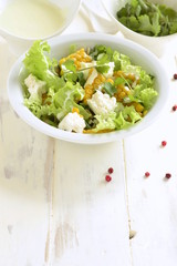 Salad with corn, greens, feta with mayonnaise sauce, copy space