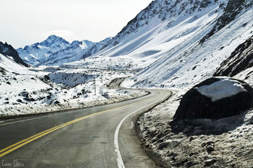 Street in between mountains and snow