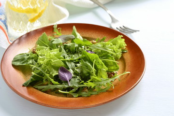 Fresh green salad with spinach, arugula, lettuce, herbs and nuts