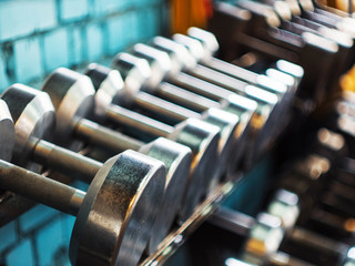 Number of dumbbells in the gym. Close up. 