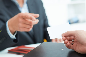 Business people change business cards on meeting seminar or conference.