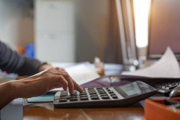 A businesswoman  using calculator investment charts at his workplace. Business concept.