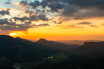 Sunrise see over mountain peaks at Rocky Mountain National Park, Colorado