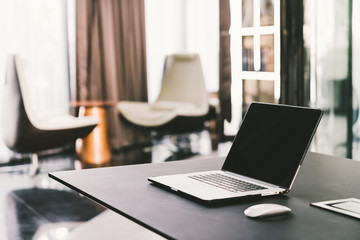 Laptop computer on work table in modern luxury contemporary office. Corporate business, internet...