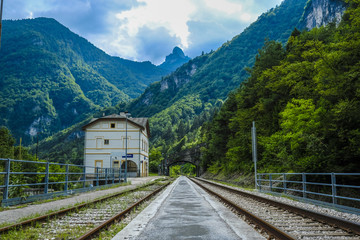 Ospitale, Italy - July, 12, 2018: Alpine landscape with the image of mountain railroad and Ospitale...