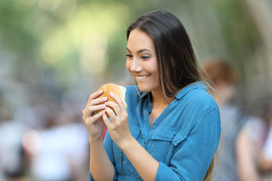 Excited woman ready to eat a burger