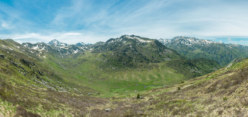 Fototapeta na wymiar Panorama of the Ruisseau le Rieutort valley in the French Pyrenees which leads up to the GR10 hiking route and the Refuge du Rulhe.