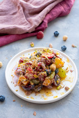 Colorful fruit salad with honey and poppy