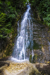 Obraz premium Alpine landscape with the image of waterfall