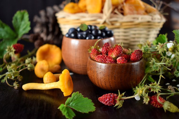 Strawberries, blueberries and chanterelles. Freshly picked forest berries and mushrooms