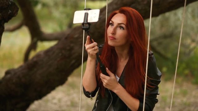 Beautiful woman making self-portrait on a smartphone.