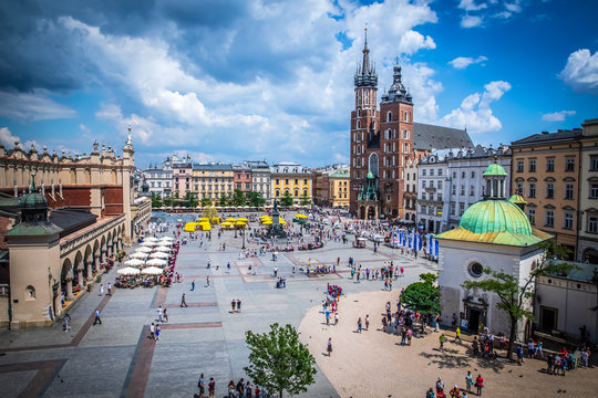 Cracow (Krakow) - Main Square (Rynek Glowny) with Marketplace (Sukiennice), Adam Mickiewicz Monument, church of Saint Mary (Kosciol Mariacki) and church of Saint Adalbert - window view